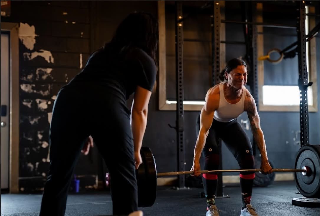 Coach JJ watching an athlete deadlift